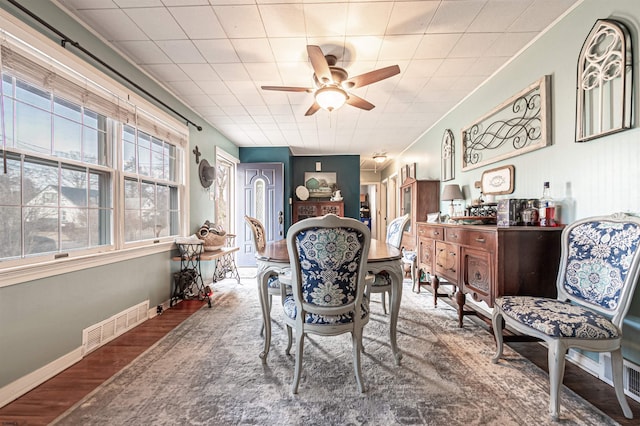 dining area with wood-type flooring and ceiling fan