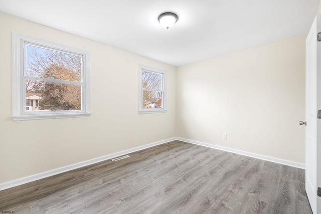 unfurnished room with light hardwood / wood-style flooring