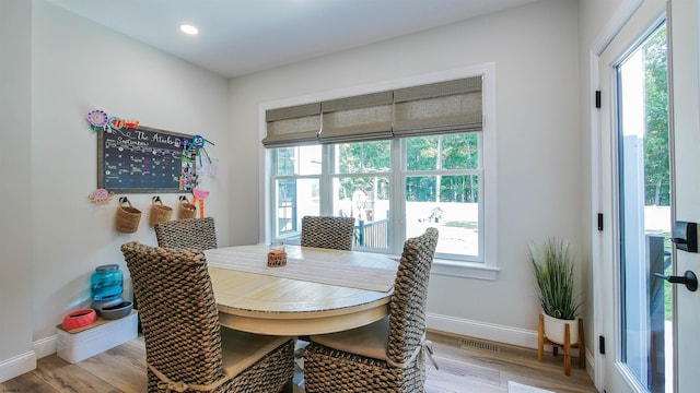 dining room with plenty of natural light and light hardwood / wood-style flooring