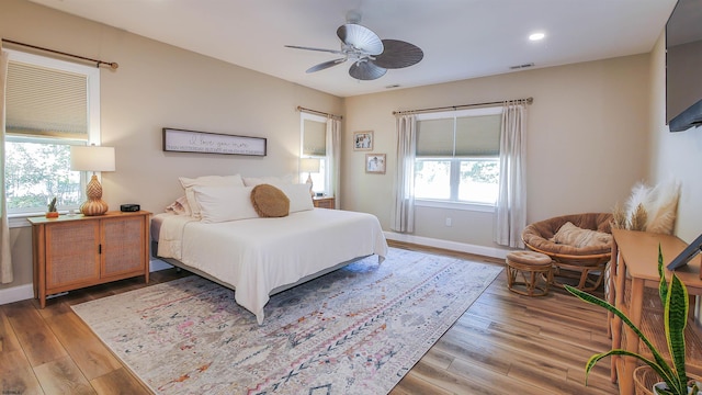 bedroom with hardwood / wood-style floors and ceiling fan