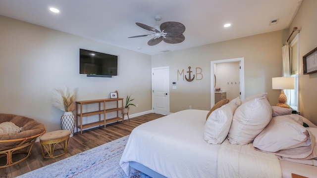 bedroom with connected bathroom, dark wood-type flooring, and ceiling fan