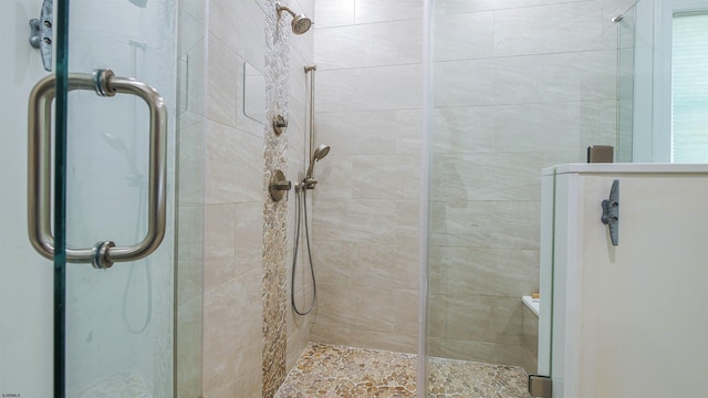 bathroom featuring a shower with door