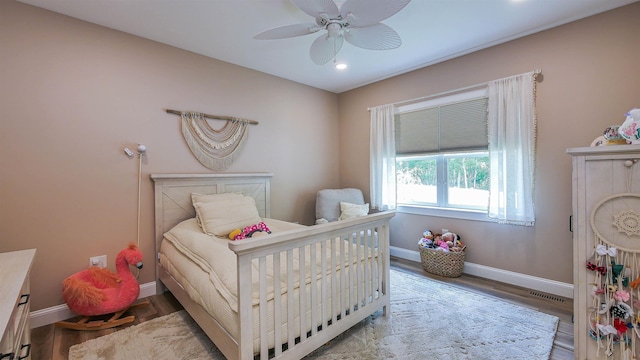 bedroom featuring hardwood / wood-style flooring and ceiling fan