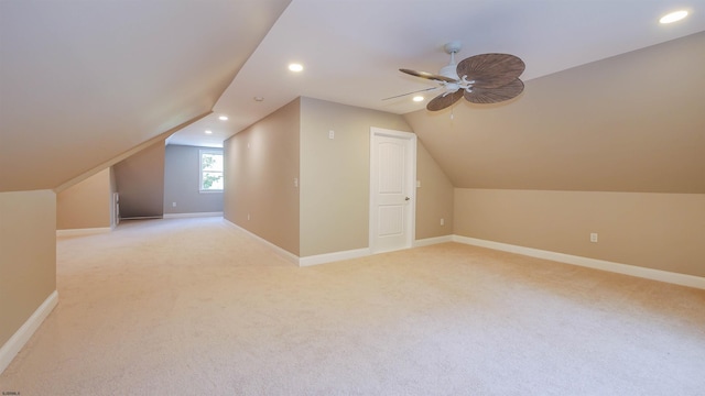 additional living space featuring ceiling fan, lofted ceiling, and light carpet