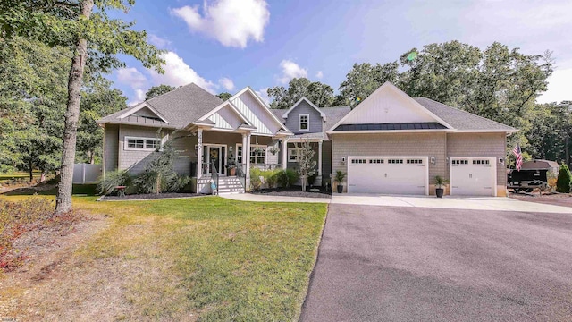 craftsman-style house featuring a garage and a front lawn