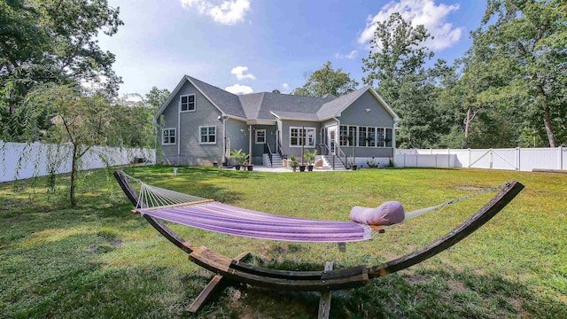 back of property featuring a yard and a sunroom