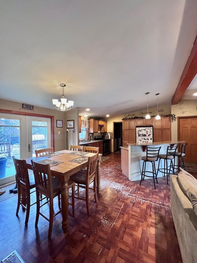 dining room featuring french doors, dark parquet floors, and a notable chandelier