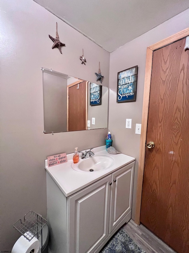 bathroom featuring vanity and hardwood / wood-style flooring