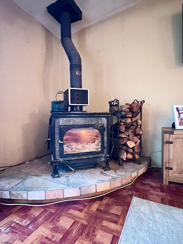 details featuring parquet floors and a wood stove