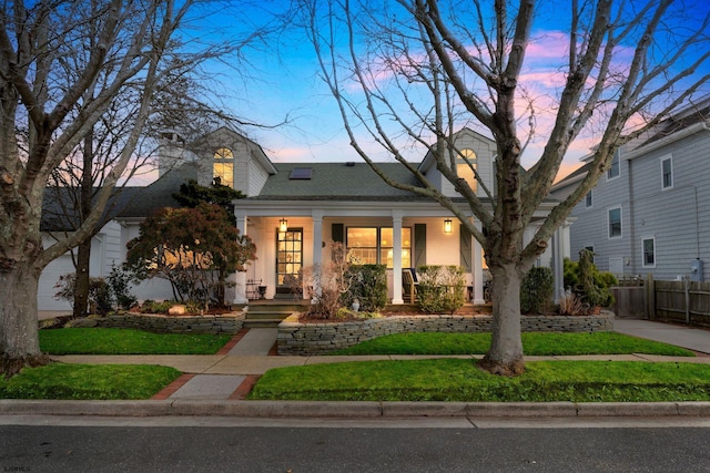 view of front of home featuring a porch and a yard