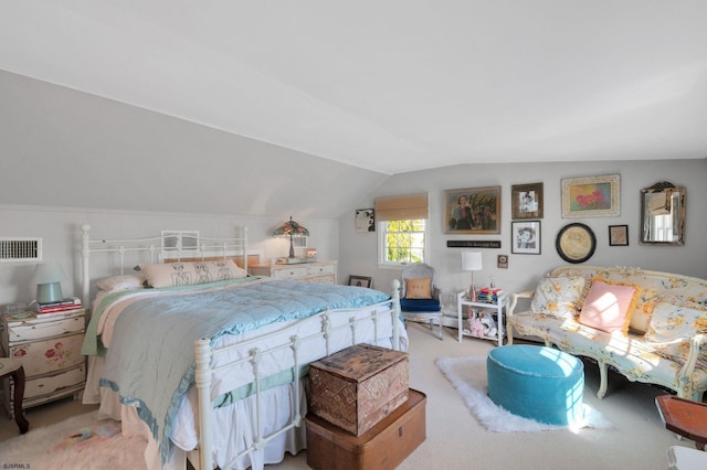 bedroom featuring light carpet and vaulted ceiling