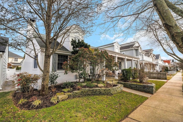 view of front of house with a porch and a front yard