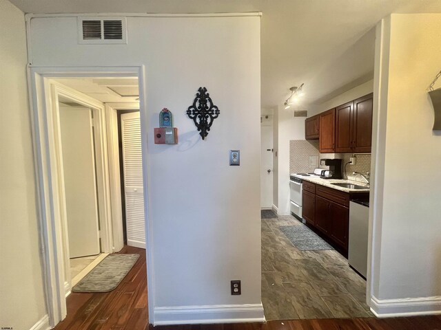 101 S Raleigh Unit 513, Atlantic City, NJ 08401 - kitchen featuring white electric range, sink, stainless steel dishwasher, dark hardwood / wood-style floors, and backsplash