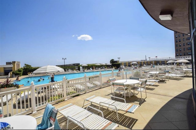 view of swimming pool featuring a patio area