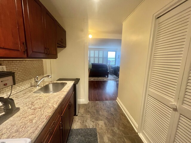 101 S Raleigh Unit 513, Atlantic City, NJ 08401 - kitchen with light stone counters, sink, and decorative backsplash