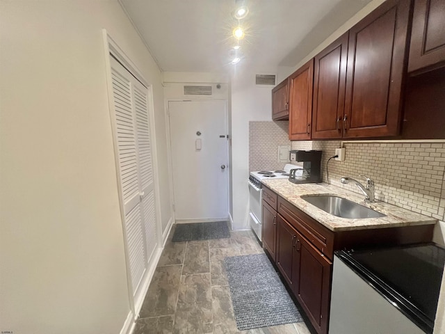 101 S Raleigh Unit 513, Atlantic City, NJ 08401 - kitchen with light stone countertops, sink, decorative backsplash, and white range with electric cooktop