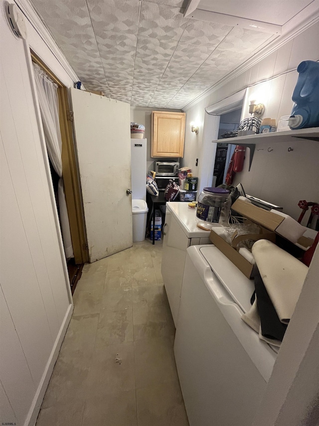 washroom featuring cabinets and independent washer and dryer