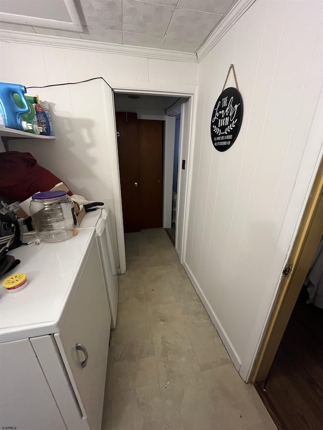 hallway featuring crown molding and washer and clothes dryer