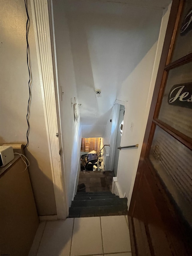stairway featuring tile patterned floors