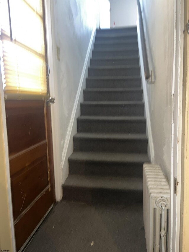 staircase featuring radiator heating unit