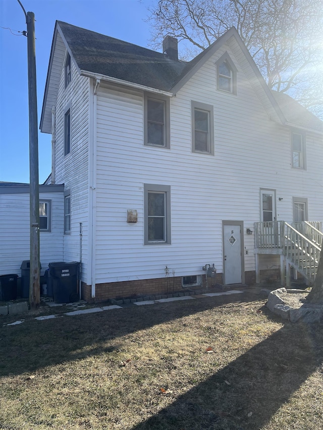 rear view of house with a lawn