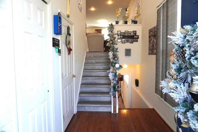 stairway with hardwood / wood-style flooring