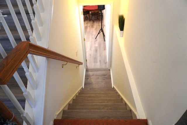 stairs with hardwood / wood-style floors