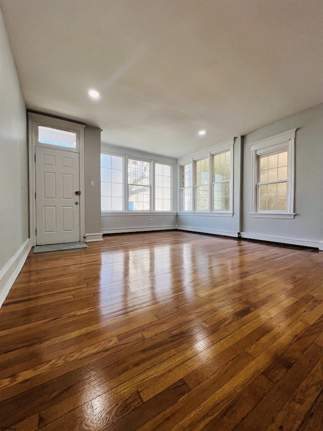 unfurnished living room with dark hardwood / wood-style flooring