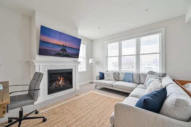 carpeted living room featuring a fireplace