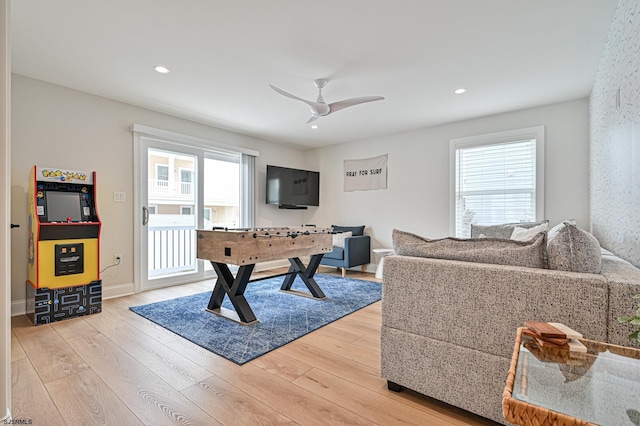 rec room with a healthy amount of sunlight, hardwood / wood-style floors, and ceiling fan