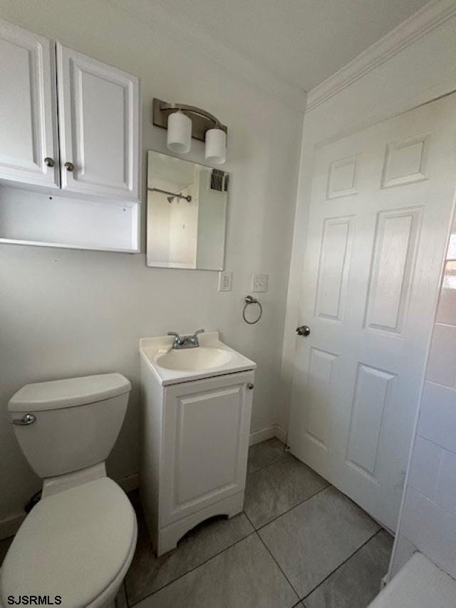 bathroom featuring vanity, ornamental molding, and toilet