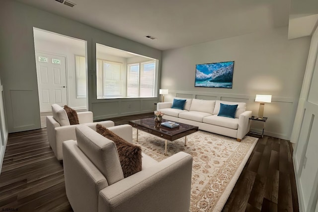 living area with visible vents and dark wood-style flooring