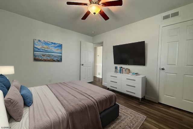 bedroom featuring dark wood-style floors, baseboards, visible vents, and a ceiling fan