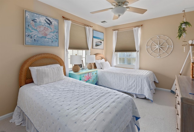 carpeted bedroom featuring multiple windows, visible vents, and baseboards