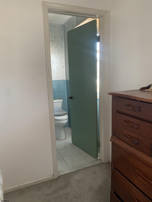 bathroom with tile patterned flooring and tile walls