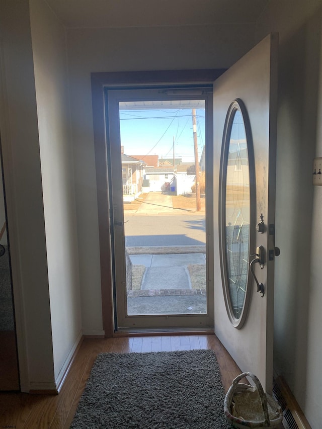 doorway to outside with wood-type flooring