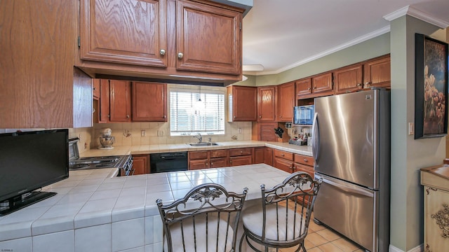 kitchen featuring stainless steel fridge, black dishwasher, tile countertops, and kitchen peninsula