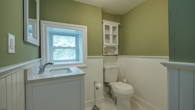 bathroom featuring tile patterned flooring, vanity, and toilet