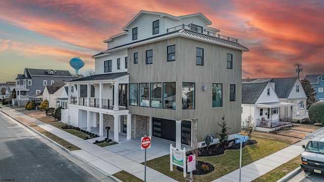 view of front of house featuring a balcony and a garage