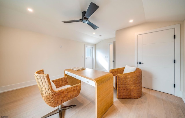 home office featuring lofted ceiling, ceiling fan, and light hardwood / wood-style flooring