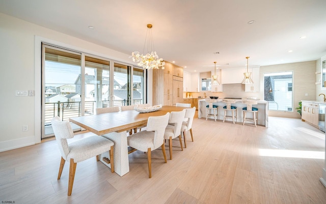 dining room featuring a notable chandelier and light hardwood / wood-style flooring