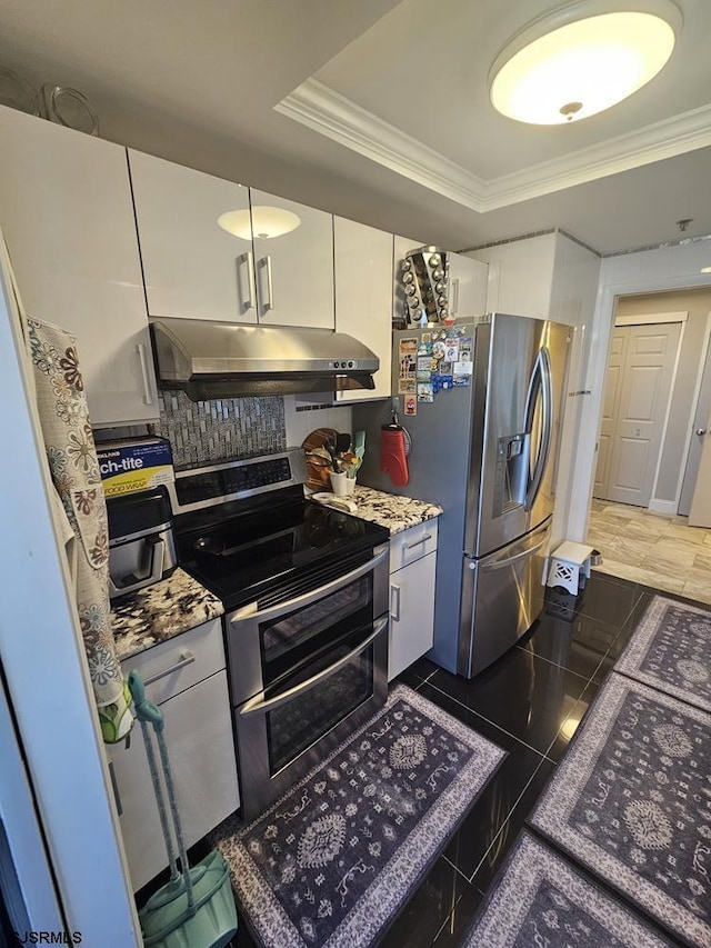 kitchen featuring ornamental molding, appliances with stainless steel finishes, a tray ceiling, and white cabinets