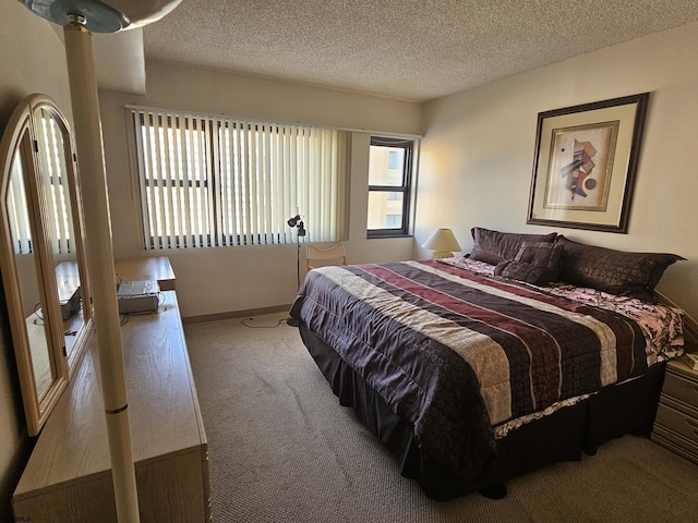 carpeted bedroom featuring a textured ceiling