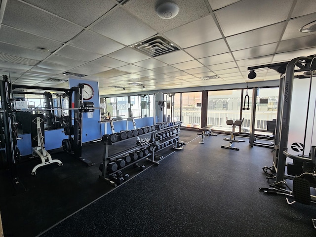 workout area featuring a paneled ceiling