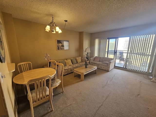 living room with a textured ceiling, carpet floors, and a chandelier