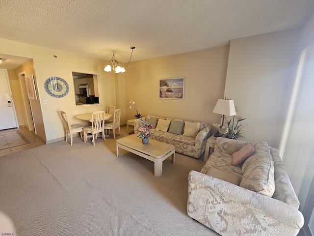 living room with carpet flooring, a notable chandelier, and a textured ceiling