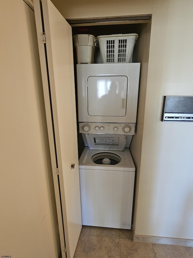 laundry area with stacked washer and clothes dryer