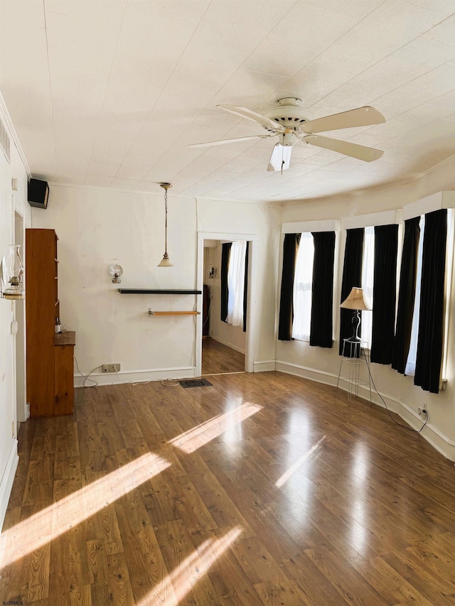 spare room with dark hardwood / wood-style flooring and ceiling fan