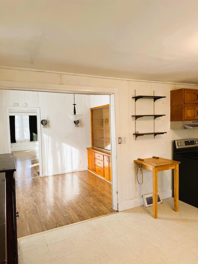 kitchen featuring stainless steel electric stove and light wood-type flooring