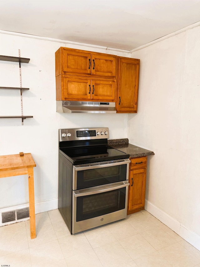 kitchen with range with two ovens and dark stone countertops